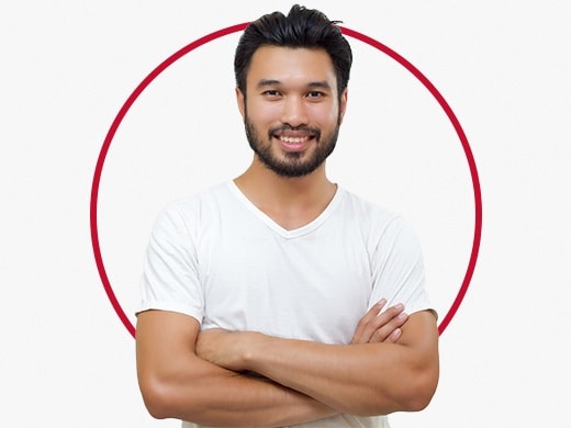 Smiling young man standing confidently and wearing grey T-shirt, happy after Canesten jock itch treatment