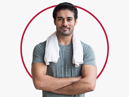 Muscular man with white towel around neck happy after Canesten heat rash treatment